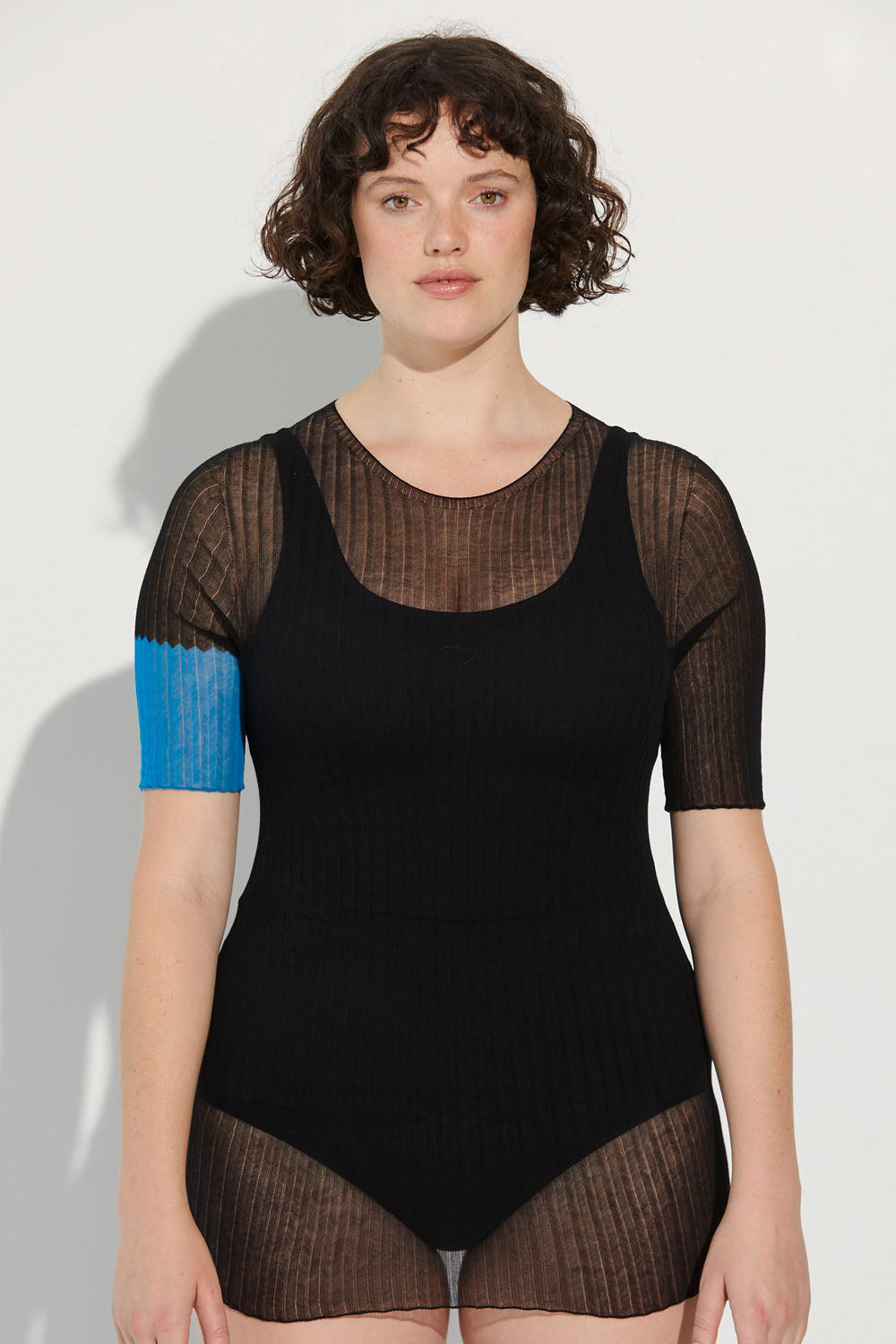 Woman standing wearing a black and azure Standard Issue Colour Block Cotton Tulle Tee.