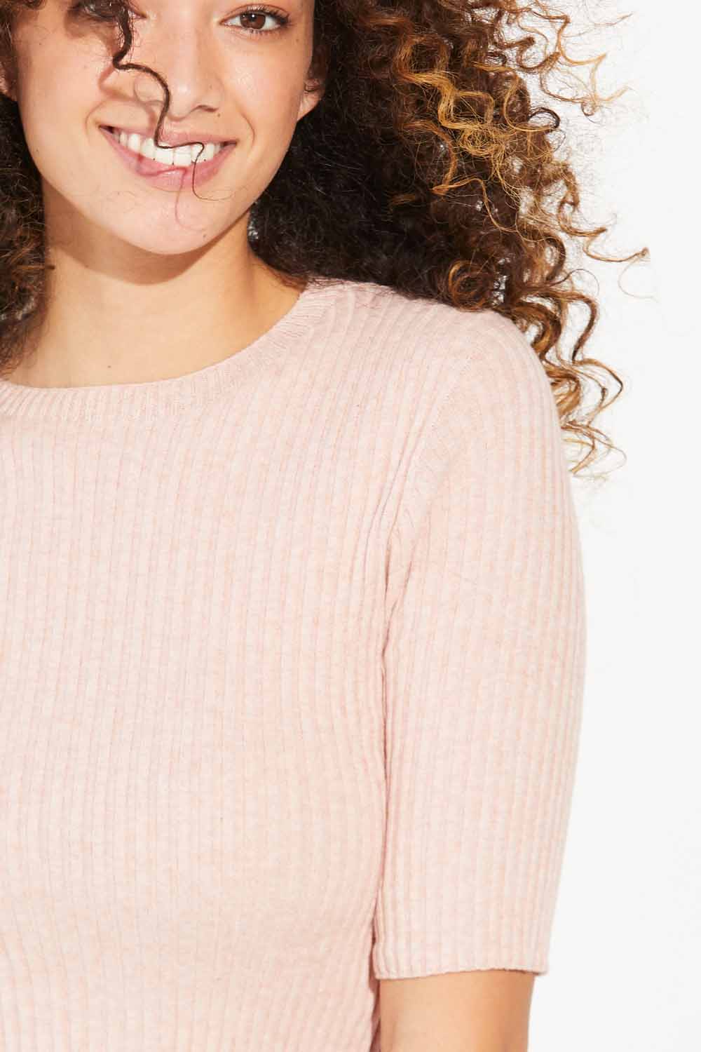 Close up of woman wearing Standard Issue Balance Crop Tee in Flamingo colour.