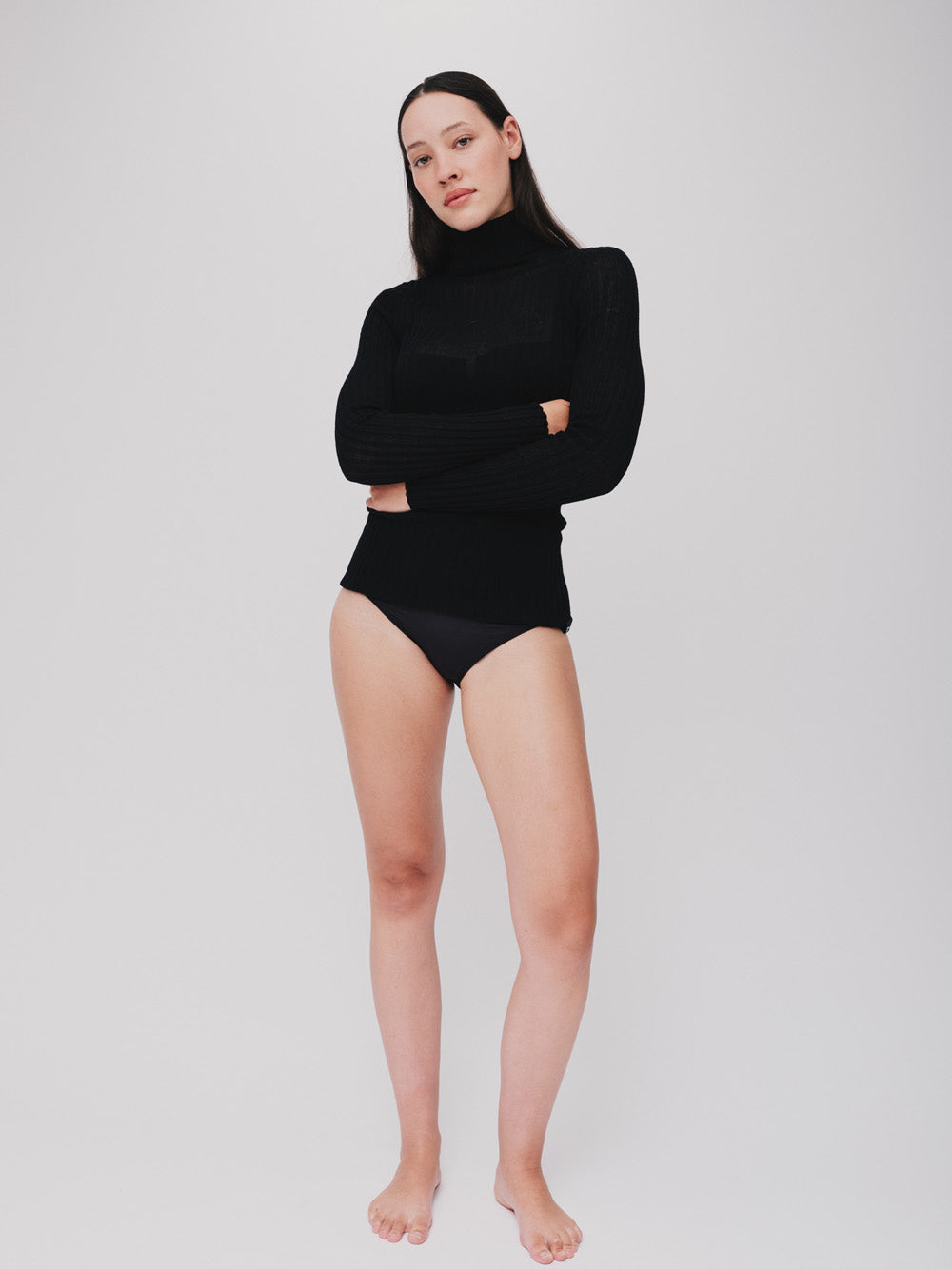 Woman wearing a sheer black tulle against a white background