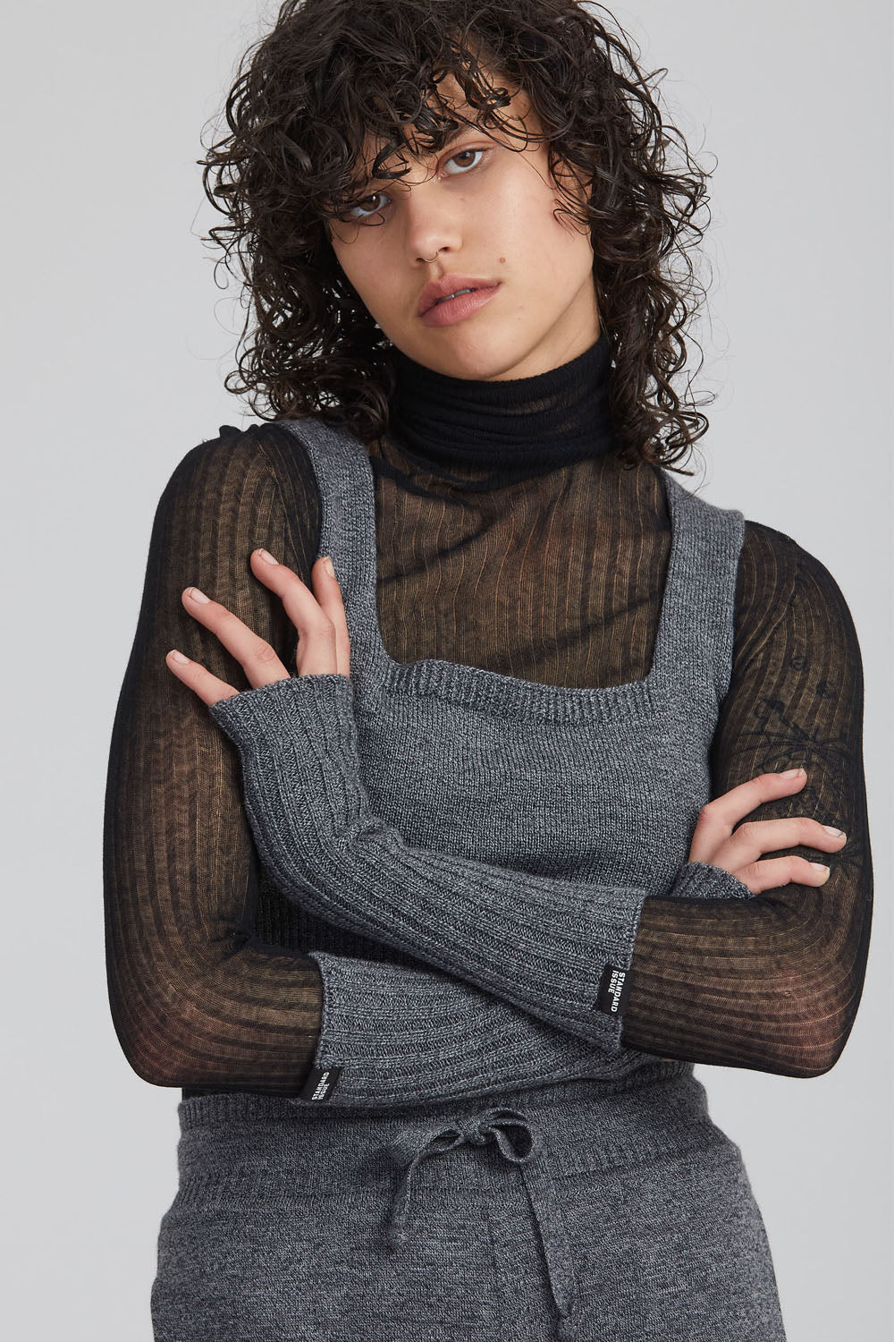 A woman wearing a marble-coloured Standard Issue Merino Little Crop Singlet.