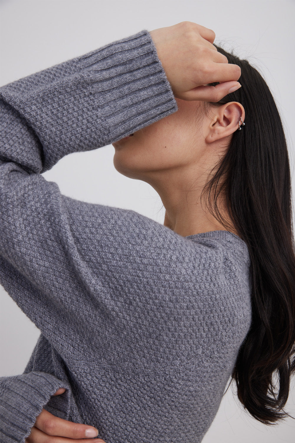 Side angle of woman wearing Italian Cashmere Snowflake Crop with moss stitch  in colour stone/