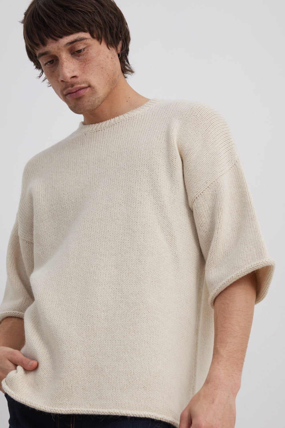 Man looking down wearing Alpaca, Merino and Cotton Blend yarn knitted tea