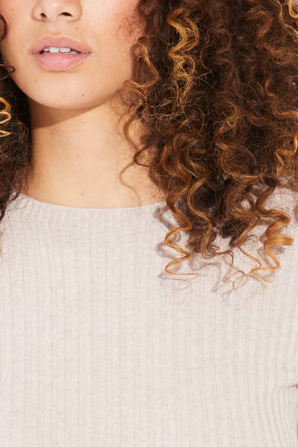 Close up of woman wearing Standard Issue Balance Crop Tee in Shell colour.