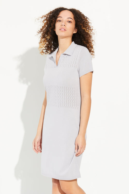 A woman standing wearing a silver cloud-coloured Standard Issue Cotton Foliage Polo Dress.